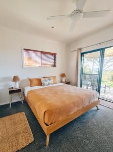 a bedroom with a large bed and a window at Seascape The Haven in Scotts Head
