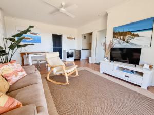 a living room with a couch and a flat screen tv at Seascape The Haven in Scotts Head