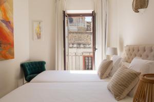 Posteľ alebo postele v izbe v ubytovaní Puerta Catedral Apartments