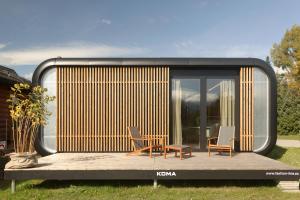 a tiny house on a deck with two chairs and a table at Liptovské Chaty - Fashion Line in Liptovský Mikuláš