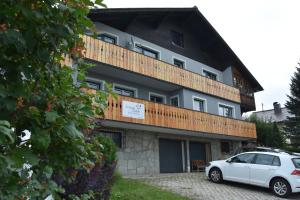 a white car parked in front of a building at Almblick Energiequelle in Bad Mitterndorf