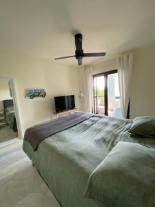sypialnia z dużym łóżkiem i wentylatorem sufitowym w obiekcie Alcaidesa Golf and Beach Resort w mieście La Alcaidesa