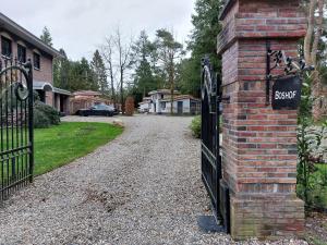 an entrance to a house with a black wrought iron gate at Villa Mar veluwe in Ermelo