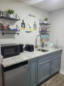 a kitchen counter with a microwave and a sink at Diamond 4 in Tampa