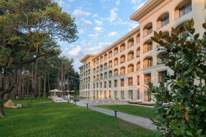 a large building with a lawn in front of it at Ensana Aquahouse in Saints Constantine and Helena