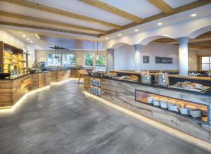 a large kitchen with wooden counters and a cafeteria at Landsitz Stroblhof in Tirolo