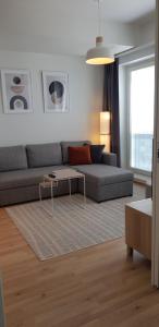 uma sala de estar com um sofá e uma mesa em City Apartment with lake view and free parking em Kuopio