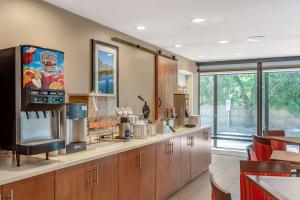 a large kitchen with wooden cabinets and a large window at Comfort Suites Oakbrook Terrace near Oakbrook Center in Oakbrook Terrace