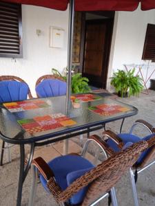 a glass table with chairs and a table with a glass at Apartment Fortica in Senj