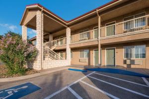 an empty parking lot in front of a building at Quality Inn in Sonora