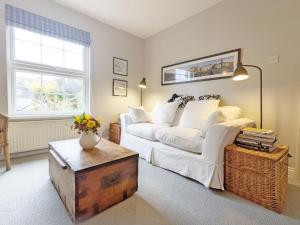 a living room with a white couch and a table at Dolphin Cottage - Hayling Island in South Hayling
