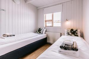 a room with two beds and a window at Hlíd Cottages in Myvatn