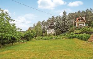 a large yard with houses in the background at Gorgeous Home In Mucharz With Sauna in Mucharz