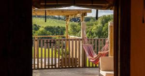 a couple of hammocks hanging on a porch at Luxury Safari Lodge surrounded by deer!! 'Roe' in Crediton
