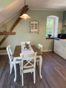 eine Küche und ein Esszimmer mit einem Tisch und Stühlen in der Unterkunft Neue Ferienwohnung im alten Forsthaus in Rüdesheim am Rhein