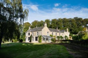 a large stone house with a large yard at Honeystone House in Hexham