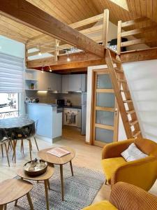a living room with a loft bed and a kitchen at Maison de Ville Lumineuse centre ville à pieds - Lit 160 in Quimper
