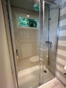 a glass shower with a toilet in a bathroom at La Casa de Invitados in Zaragoza