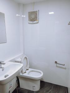 a white bathroom with a toilet and a sink at ปรุงสุข in Phra Nakhon Si Ayutthaya