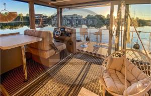 a balcony on a boat with a table and chairs at Cozy Ship In Havelsee With Kitchen in Milow