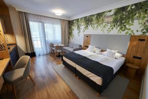 a hotel room with a bed and a living wall at Chaber Apartamenty in Swornegacie 