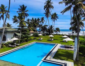 a view of the pool and beach at Crystal Villa in Weligama
