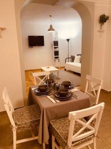 a living room with a table and chairs and a couch at Tar Pizza La Casa in Debrecen
