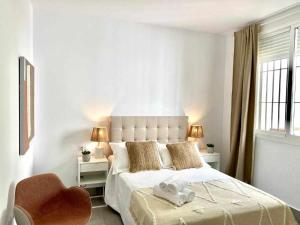 Łóżko lub łóżka w pokoju w obiekcie Apartamentos Casa Macías