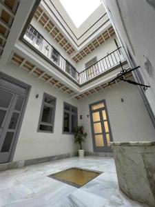 um quarto grande com uma porta e um tecto em Apartamentos Casa Macías em Cádiz