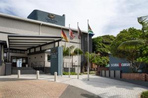a building with flags in front of it at Premier Resort Cutty Sark in Scottburgh