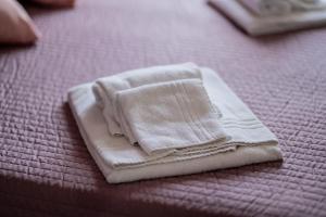 a white towel sitting on top of a bed at DREAMS IN ROME - COLOSSEUM APARTMENT in Rome +46 photos