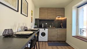 a kitchen with a washer and dryer on a counter at Nouveau* Vintage Mecanic* Wifi*Netflix*Confort in Venette