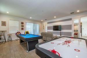 a living room with a pool table and a tv at Sonoma Resort 7 Bedroom Vacation Home 2600YA in Kissimmee