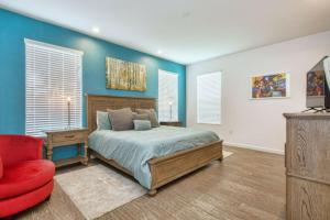 a bedroom with a bed and a red chair at Sonoma Resort 7 Bedroom Vacation Home 2600YA in Kissimmee