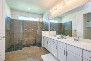 a bathroom with two sinks and a shower at Sonoma Resort 7 Bedroom Vacation Home 2600YA in Kissimmee +35 photos