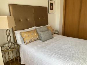 a bedroom with a bed with white sheets and pillows at HyP - Camino Conde in Puentesampayo