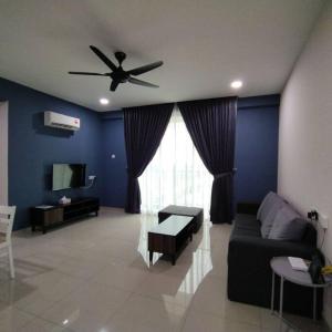 a living room with a couch and a ceiling fan at 191 Cozy Casa Kayangan 3BR 6pax by Grab A Stay in Ipoh
