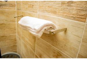 a towel hanging on a wall in a bathroom at R Executive Apartments in Harare +75 photos