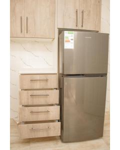 a stainless steel refrigerator in a kitchen with wooden cabinets at R Executive Apartments in Harare