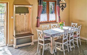 a dining room with a table and chairs at 3 Bedroom Amazing Home In Kopalino in Kopalino