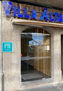 a entrance to a building with a sign on it at Villa Alta in Villalba