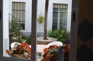 a view of a table and chairs from a window at CASA DOROTEO in Cardeña