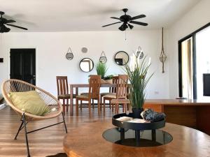 a living room with a table and chairs and a ceiling fan at Jonty Villa, Mazotos in Larnaka