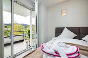 a bedroom with a bed and a balcony at Enjoy ONE in Altenmarkt im Pongau