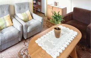 a living room with a table with a potted plant on it at Holiday Home Morag Kretowiny V in Pojezierce
