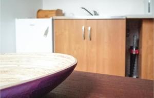 a kitchen counter with a sink and a wooden table at Holiday Home Morag Kretowiny V in Pojezierce +7 photos