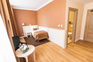 Postel nebo postele na pokoji v ubytování Wellness Hotel Pivovar Monopol