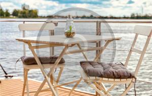 a table and two chairs on a boat at Awesome Ship In Neuruppin With Kitchen in Neuruppin