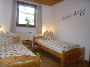a bedroom with two beds and a window at Jüttis in Wimbach