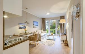 a kitchen and living room with a couch and a table at Baltischer Hof Apartment 13 in Boltenhagen
